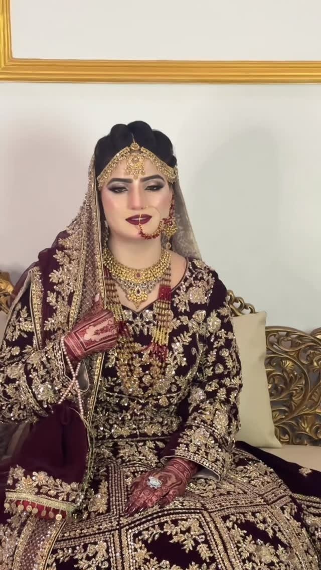 Deep maroon bridal look with gold jewellery